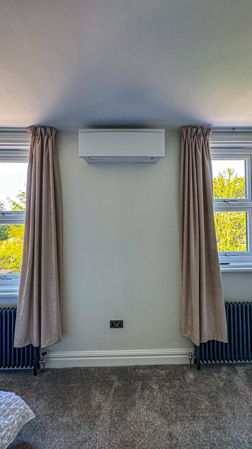 Wall-mounted air conditioning unit in a bedroom