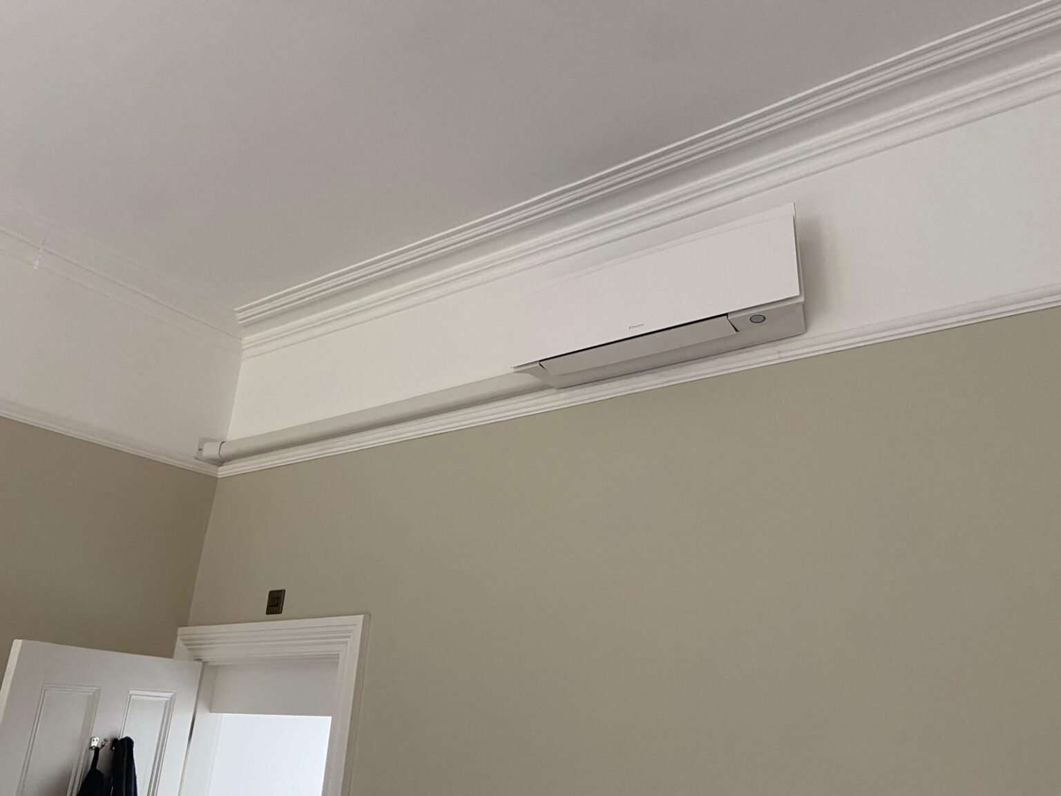 White wall-mounted air conditioning unit installed by AKS in a home