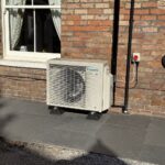 Daikin outdoor condenser unit neatly installed on patio against brickwork