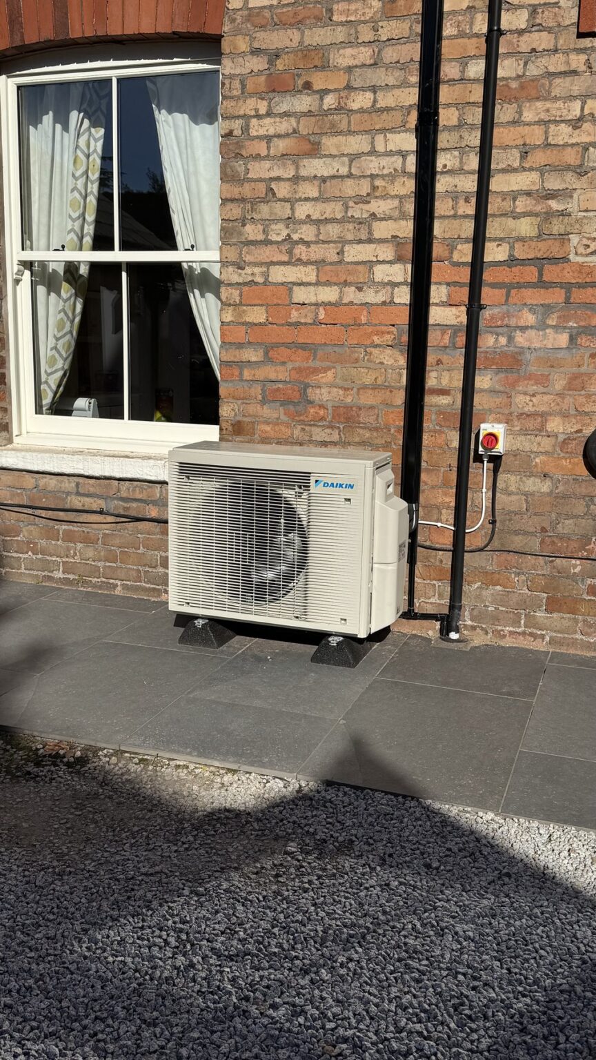 Outdoor air conditioning unit neatly installed on a brick wall