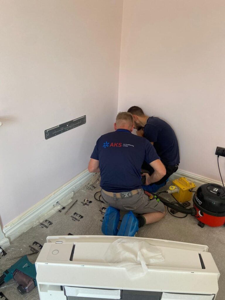 AKS engineers installing home air conditioning