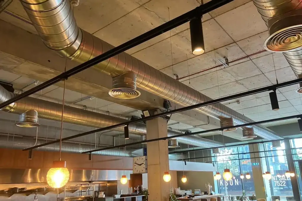 Spiral extract ductwork and ventilation services running across the ceiling of a commercial restaurant fit-out