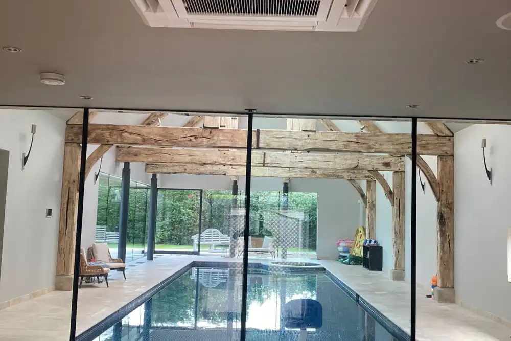 Indoor pool and gym in an existing home, climate controlled with air conditioning by AKS
