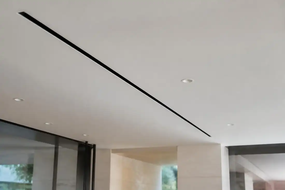 Plastered-in linear slot air conditioning grille on an AKS luxury home project